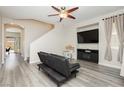 Cozy living room featuring modern flooring, a ceiling fan, large TV, and comfortable seating at , Las Vegas, NV 89178