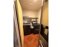 Efficient laundry room setup with front-load washer and dryer at 1001 Declaration Dr, Las Vegas, NV 89110