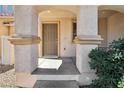 Charming front porch with decorative columns and a neutral-toned front door at 1043 Monte De Oro Ave, Las Vegas, NV 89183