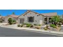 Single-story home featuring desert landscaping, stone accents, and a well-maintained lawn at 10608 Trussell St, Las Vegas, NV 89141