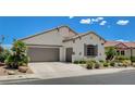 Inviting single-story home features a desert landscape and a two-car garage at 10608 Trussell St, Las Vegas, NV 89141