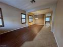 Bright living room with hardwood floors, neutral tones, and an open layout flowing into other living spaces at 11237 Newbury Hills Ave, Las Vegas, NV 89138