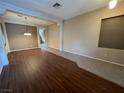 Spacious living area with hardwood floors, neutral walls, and plenty of natural light from big windows at 11237 Newbury Hills Ave, Las Vegas, NV 89138