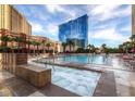Refreshing outdoor pool with lounge chairs and a hot tub at 135 E Harmon Ave # 518, Las Vegas, NV 89109