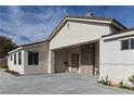 Stylish home features a porte-cochere with stone accents and drought tolerant landscaping at 1409 Denver St, Boulder City, NV 89005