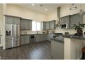 Gray kitchen with stainless steel appliances, granite counters, and wood-look floors at 1409 Denver St, Boulder City, NV 89005