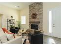 Inviting living room with a floor-to-ceiling stone fireplace, light yellow walls, and elegant decor at 1409 Denver St, Boulder City, NV 89005