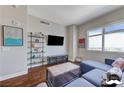 Bright living room with hardwood floors, modern shelving, and a large window offering scenic views at 150 Las Vegas Blvd # 1118, Las Vegas, NV 89101