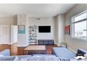 Cozy living room featuring hardwood floors, a mounted TV, and a large window at 150 Las Vegas Blvd # 1118, Las Vegas, NV 89101