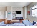 Cozy living room showcasing a large window, modern shelving, and hardwood floors throughout at 150 Las Vegas Blvd # 1118, Las Vegas, NV 89101