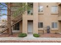 Inviting condo exterior featuring a private entryway and convenient stair access, complemented by mature trees and shrubs at 2110 Los Feliz St # 1066, Las Vegas, NV 89156