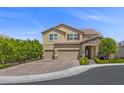 Beautiful two-story home features a three-car garage, stone detailing, and lush landscaping, enhancing its curb appeal at 2400 Trissino Ct, Henderson, NV 89044