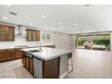 Stylish kitchen with a large island, stainless steel appliances, and seamless flow into the living area at 2434 Quiet Ode St, Henderson, NV 89044
