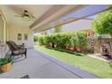 Relaxing covered patio overlooking an artificial lawn and an outdoor water feature at 2545 Nashira St, Henderson, NV 89044