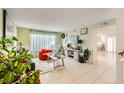 A cozy living room with tiled floors, bright windows, and colorful accents and decor at 27 Sirnoble St, Las Vegas, NV 89110