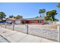 This single-story home showcases mature trees, a two-car garage, and a charming brick facade at 2700 Osborne Ln, Henderson, NV 89014