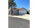 Charming single-story home features a two-car garage, red-tiled roof and neutral paint at 2721 Coffee Pot Ct, Las Vegas, NV 89106