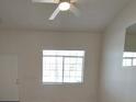Bright living room featuring a ceiling fan, neutral paint, and view to the exterior at 2721 Coffee Pot Ct, Las Vegas, NV 89106