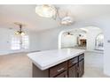 Kitchen island with dark wood cabinets, tile countertops, and vintage pendant lighting at 2825 Burnham Ave, Las Vegas, NV 89169