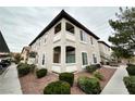 A building exterior showcases a well-maintained corner unit with a view of the covered parking at 3354 Indian Shadow St # 203, Las Vegas, NV 89129