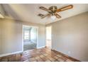 Neutral living room with tile flooring, ceiling fan, and multiple doorways to other rooms at 3434 Toquima Cir, Las Vegas, NV 89120