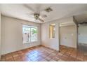 Bright living room featuring tile floors, a ceiling fan, and natural light at 3434 Toquima Cir, Las Vegas, NV 89120