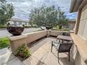 Cozy front porch with flagstone and outdoor seating perfect for relaxing and enjoying the neighborhood view at 3476 Ridge Meadow St, Las Vegas, NV 89135
