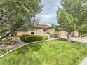 Manicured front yard with mature trees and shrubs, showcasing the home's curb appeal at 3476 Ridge Meadow St, Las Vegas, NV 89135