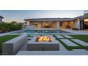 Inviting backyard with pool, fire pit, artificial turf and covered patio, perfect for outdoor entertaining at 4070 N Tee Pee Ln, Las Vegas, NV 89129