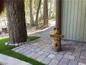 Landscaped walkway featuring a quaint welcome statue and stone pavers at 4125 Tyrol Way, Las Vegas, NV 89124