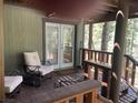 Charming porch area with comfortable seating and wooded views at 4125 Tyrol Way, Las Vegas, NV 89124