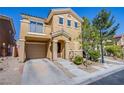 Two-story home with tan stucco, attached garage, and manicured yard is located in a desirable community at 433 Royal Bridge Dr, Las Vegas, NV 89178