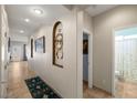 Inviting hallway featuring decorative niches, neutral paint and tile flooring at 4410 S Gressa St, Pahrump, NV 89061