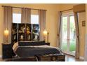 Bright bedroom with a decorative privacy screen and patio access, offering serene views at 4554 Blue Mesa Way, Las Vegas, NV 89129
