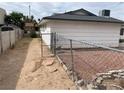 Backyard showing access to side yard, chain link fence, and desert landscaping at 4564 Dennis Way, Las Vegas, NV 89121