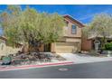 Inviting two-story home featuring neutral stucco, a two car garage, and a manicured front yard at 484 Merseyside Dr, Las Vegas, NV 89178