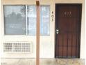 Unit 403's front entrance showcases a security door, window, and convenient access to air conditioning at 4955 Jeffreys St # 403, Las Vegas, NV 89119