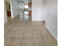 An open concept living room features tile floors, and easy access to the kitchen and bathroom areas at 4955 Jeffreys St # 403, Las Vegas, NV 89119