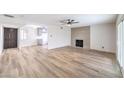 Spacious living room with wood flooring, a modern fireplace, and access to the backyard through sliding glass doors at 516 Donner St, Las Vegas, NV 89107
