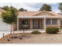 Inviting front porch with a cozy bench and decorative landscaping at 5260 Styers St, North Las Vegas, NV 89031