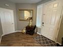 Inviting entryway featuring a stylish mirror, tile rug, and wood-look flooring at 5318 Rio Eldorado Ct, North Las Vegas, NV 89031