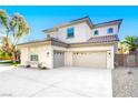 Front exterior view of a two-story house with a well-manicured lawn and mature trees at 5737 Heather Breeze Ct, Las Vegas, NV 89141