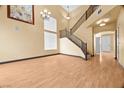 Bright living room with beautiful staircase, laminate flooring, and natural light at 6088 Gulf Island Ave, Las Vegas, NV 89156