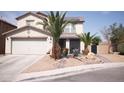 Two story home featuring desert landscaping, an attached two car garage and a walkway to the front door at 6141 Annville Ct, North Las Vegas, NV 89081