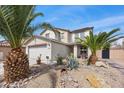 Inviting two-story home featuring desert landscaping, palm trees and a two-car garage at 6141 Annville Ct, North Las Vegas, NV 89081