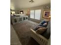 Spacious living room with carpeted floors, light gray walls, and modern furniture at 6141 Annville Ct, North Las Vegas, NV 89081
