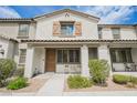 Charming townhouse featuring a covered porch, neutral stucco, and well-maintained landscaping at 6228 Haiku Stairs St, Las Vegas, NV 89148