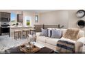 Open floor plan with modern kitchen that flows into a living area with comfortable seating and decor at 627 Bellus Pl # Lot 156, Henderson, NV 89015