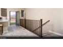 Bright living area with light wood floors, stairs and a view of the outdoors from an adjacent balcony at 627 Bellus Pl # Lot 156, Henderson, NV 89015