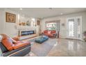 Inviting living room with a modern fireplace, tile floors, and stylish decor at 6453 Mount Eden Ave, Las Vegas, NV 89139